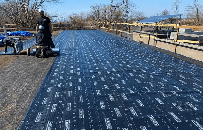 Commercial flat roof installation using modified bitumen membrane on a commercial building.
